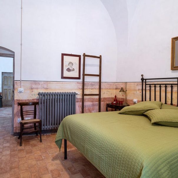 Historic furnishings of the double bedroom of the Dimora Cagnazzi Bed and Breakfast in Altamura. King size bed.